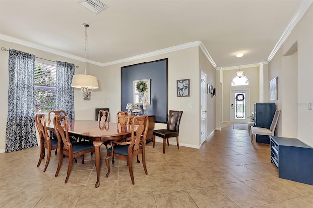 dining area featuring ornamental molding, light tile flooring, and a wealth of natural light