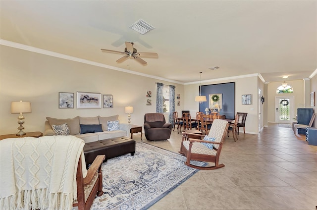 living room with light tile floors, ornamental molding, and ceiling fan