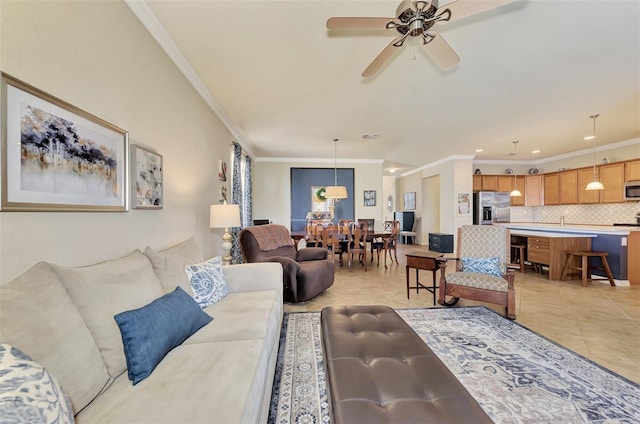 tiled living room featuring crown molding and ceiling fan with notable chandelier