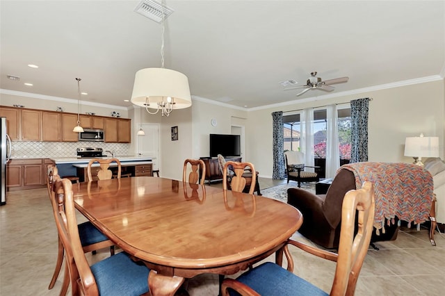 dining space with ornamental molding, light tile floors, and ceiling fan with notable chandelier