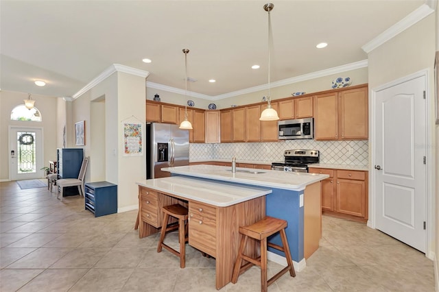 kitchen with a kitchen bar, hanging light fixtures, stainless steel appliances, and a kitchen island with sink