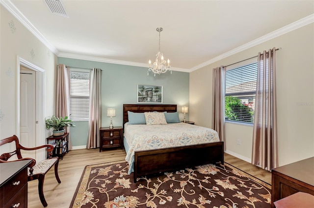 bedroom featuring a notable chandelier, ornamental molding, and light hardwood / wood-style flooring