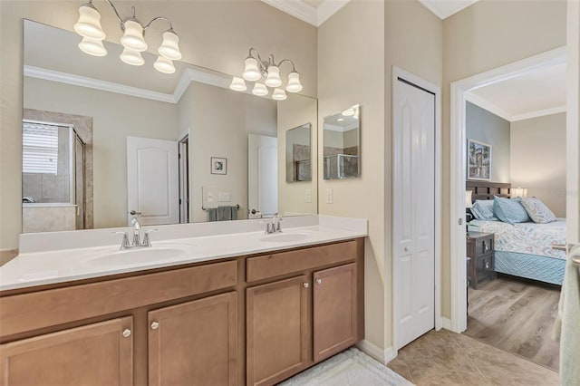 bathroom featuring double sink, an inviting chandelier, tile flooring, crown molding, and large vanity