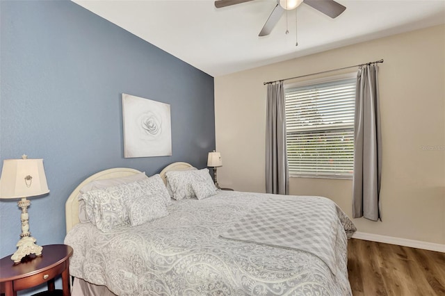 bedroom with ceiling fan and dark hardwood / wood-style flooring