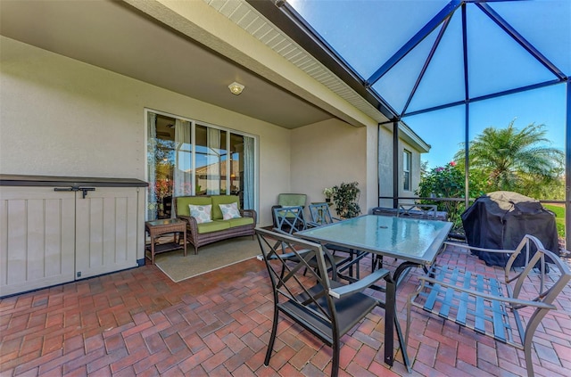 view of patio with glass enclosure