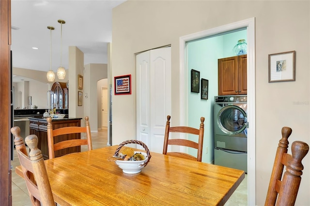 dining area with washer / clothes dryer and light tile patterned flooring