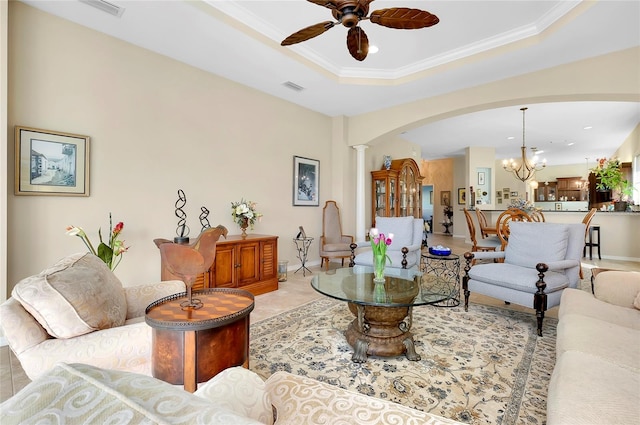 living room featuring ceiling fan with notable chandelier, a tray ceiling, and crown molding