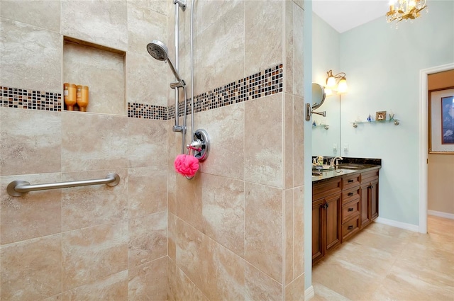 bathroom with vanity and tiled shower