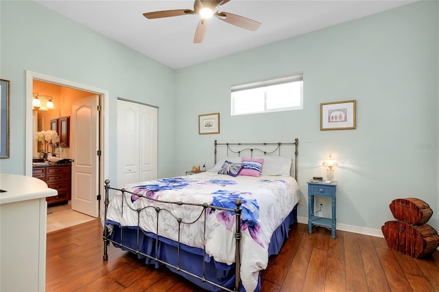 bedroom with connected bathroom, a closet, dark hardwood / wood-style floors, and ceiling fan