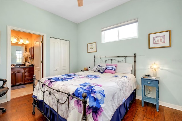 bedroom with ceiling fan, a closet, dark wood-type flooring, and connected bathroom