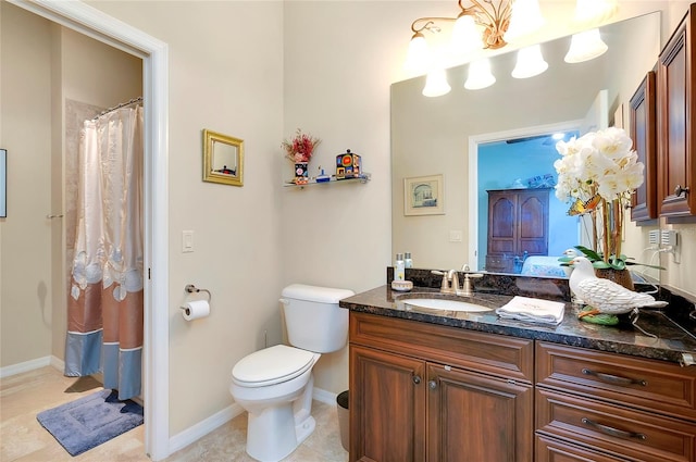 bathroom featuring tile patterned flooring, vanity, and toilet