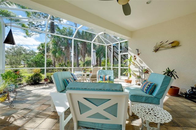 view of patio featuring a lanai and ceiling fan