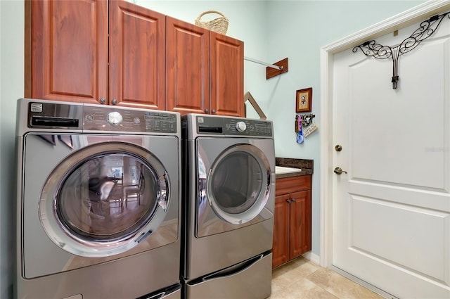 laundry room featuring independent washer and dryer and cabinets