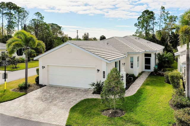 ranch-style home featuring a front lawn and a garage