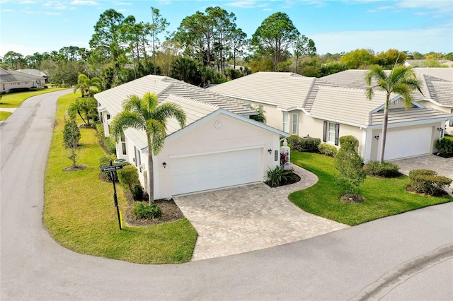 view of front of home with a front yard and a garage