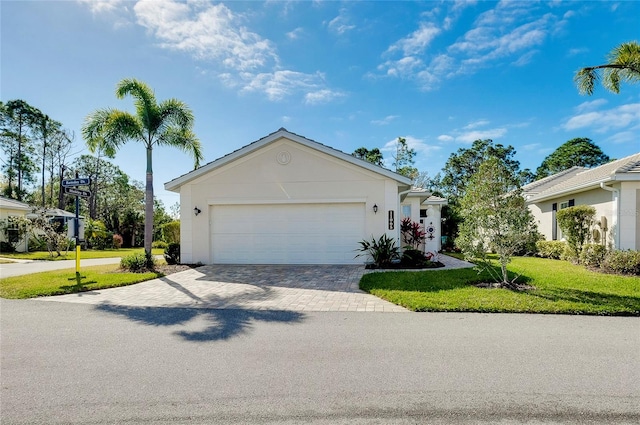 ranch-style house with a front yard and a garage