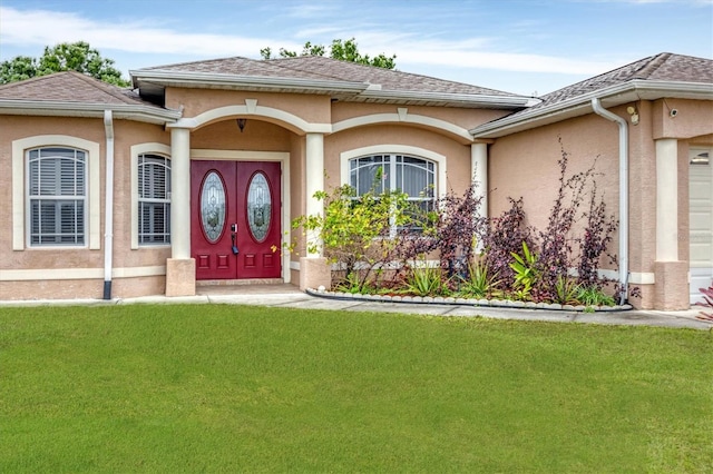 view of exterior entry with a lawn