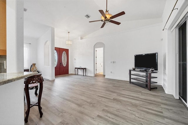 living room featuring french doors, high vaulted ceiling, wood-type flooring, and ceiling fan with notable chandelier