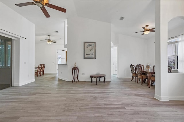 sitting room featuring vaulted ceiling, ceiling fan, and light hardwood / wood-style flooring