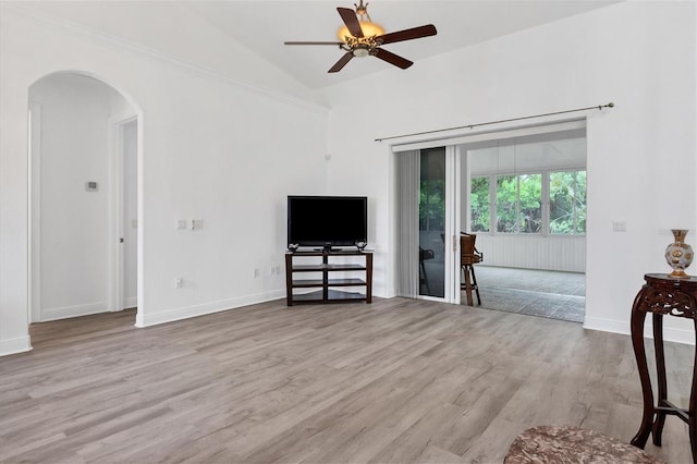 living room with lofted ceiling, ceiling fan, and light wood-type flooring