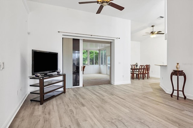 living room with ceiling fan and light wood-type flooring