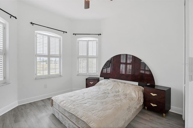 bedroom with light hardwood / wood-style floors and ceiling fan