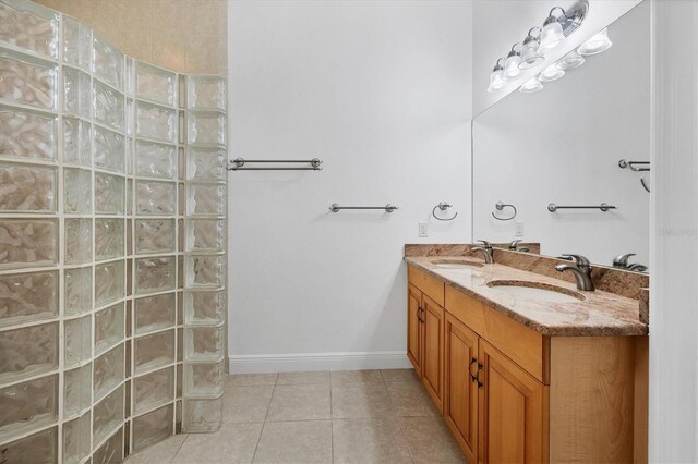 bathroom featuring tile floors and dual vanity