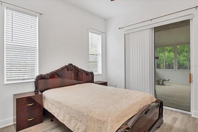 bedroom featuring multiple windows and light hardwood / wood-style flooring