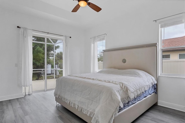 bedroom featuring multiple windows, ceiling fan, and hardwood / wood-style flooring