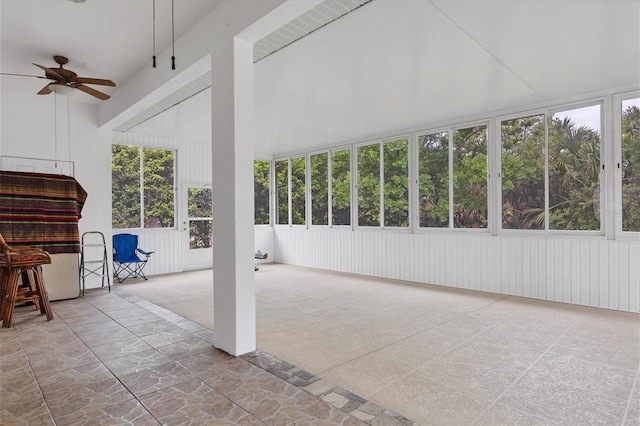 unfurnished sunroom featuring ceiling fan