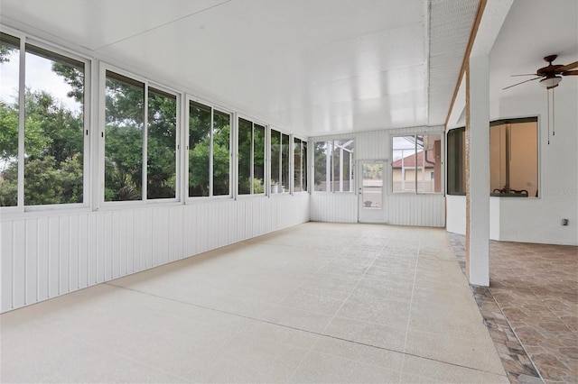 unfurnished sunroom featuring ceiling fan