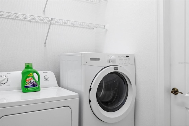 washroom with washing machine and clothes dryer