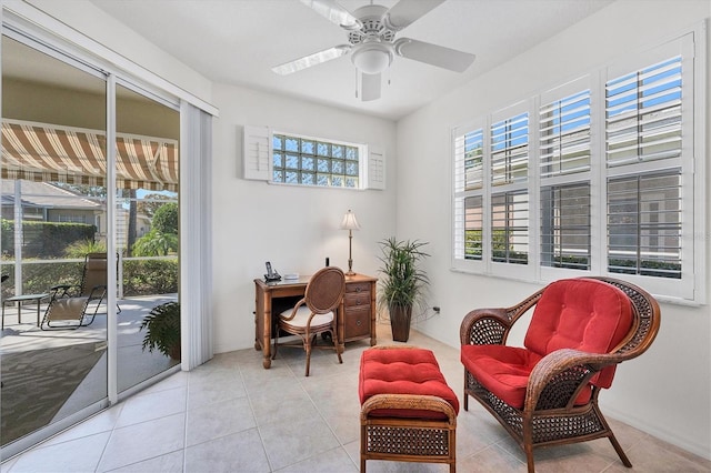 sitting room with light tile floors and ceiling fan