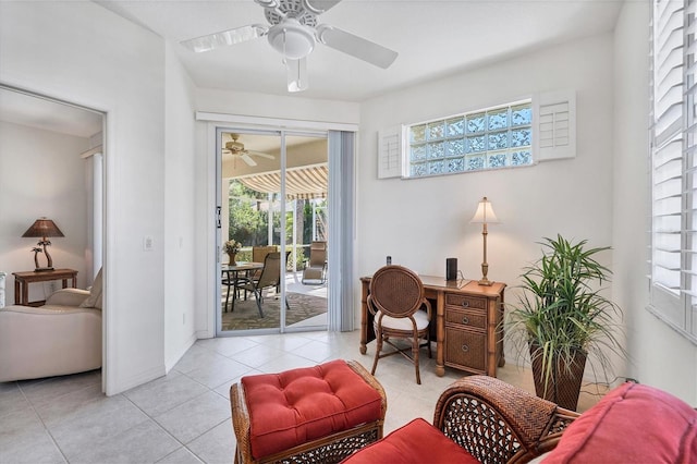 living area featuring ceiling fan, a wealth of natural light, and light tile flooring