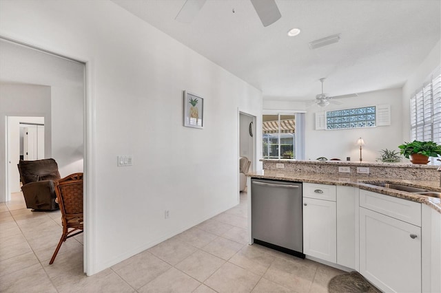 kitchen with light tile floors, ceiling fan, white cabinetry, dishwasher, and light stone counters