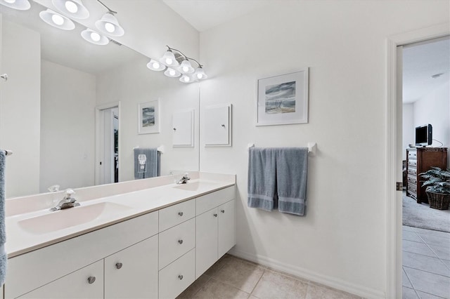 bathroom with large vanity, dual sinks, and tile floors