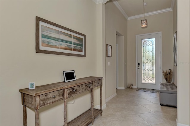 foyer with crown molding and light tile patterned floors