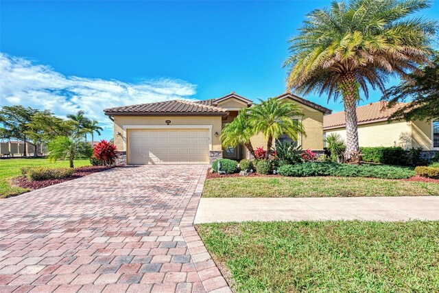 mediterranean / spanish-style house featuring a front lawn and a garage