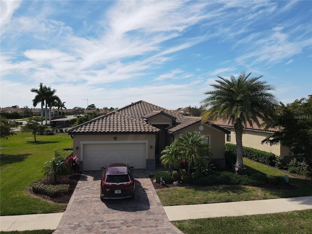 mediterranean / spanish-style house featuring a front lawn and a garage