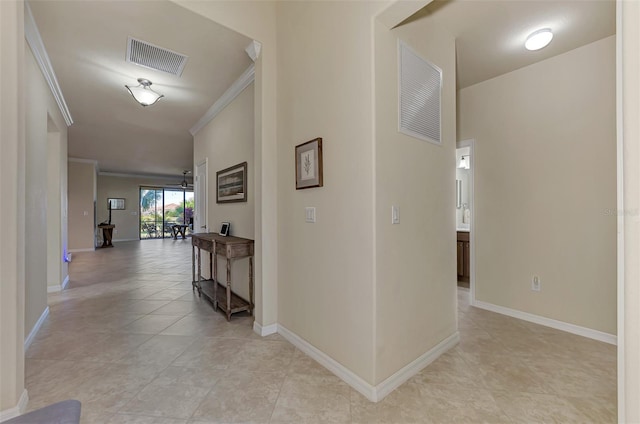 hallway featuring light tile patterned flooring and ornamental molding