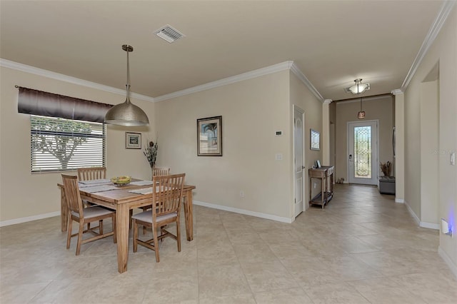 tiled dining area featuring plenty of natural light and ornamental molding