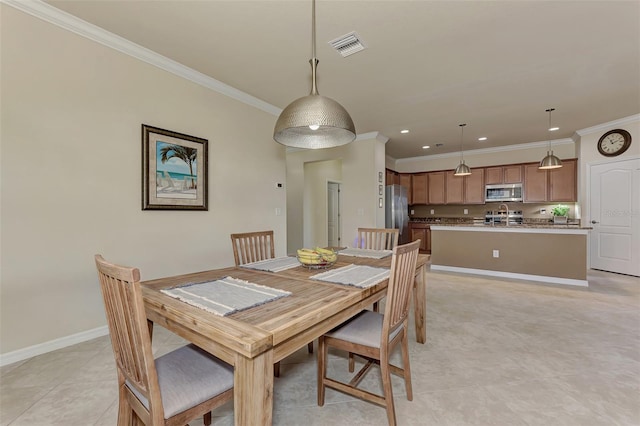 dining room featuring light tile patterned flooring and ornamental molding