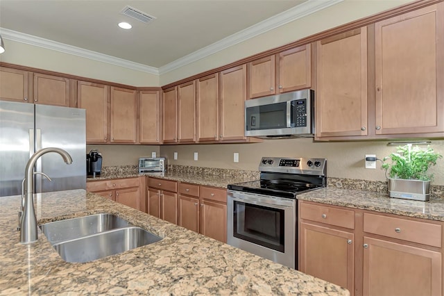 kitchen with stainless steel appliances, light stone counters, crown molding, and sink