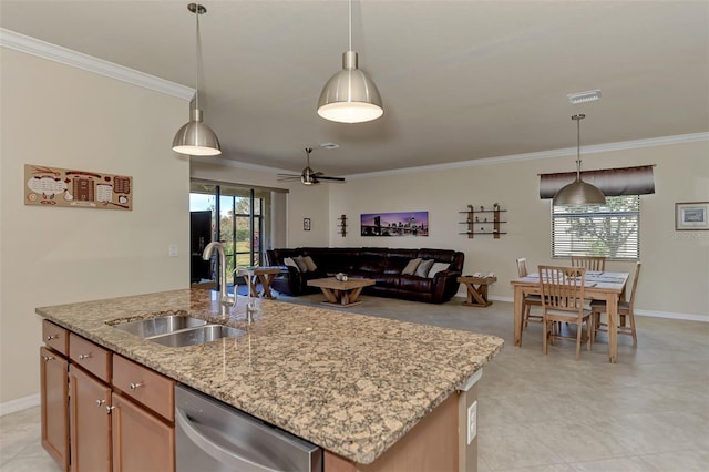 kitchen featuring ceiling fan, dishwasher, sink, an island with sink, and decorative light fixtures