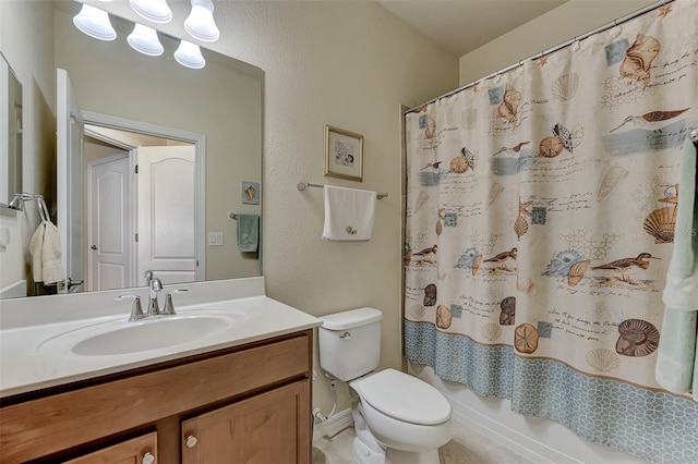 full bathroom featuring shower / bath combo with shower curtain, vanity, and toilet