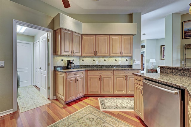 kitchen with light hardwood / wood-style floors, stainless steel dishwasher, ceiling fan, and tasteful backsplash