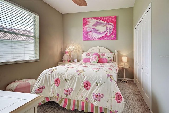 bedroom featuring a closet, light colored carpet, and ceiling fan