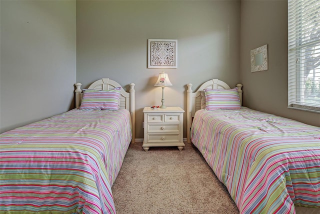 bedroom featuring light carpet