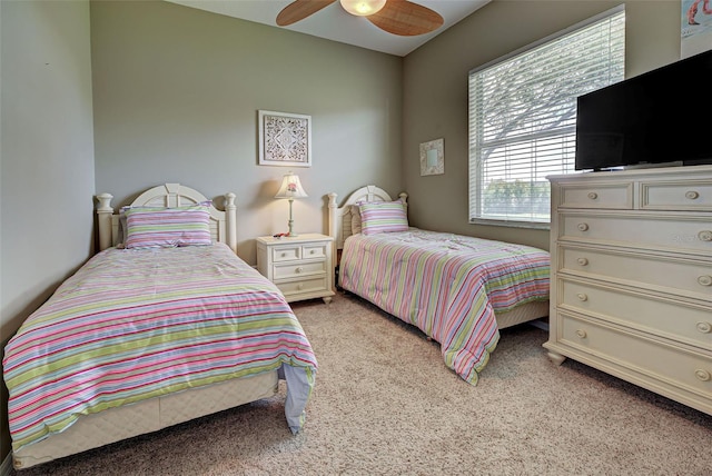 bedroom with light carpet and ceiling fan