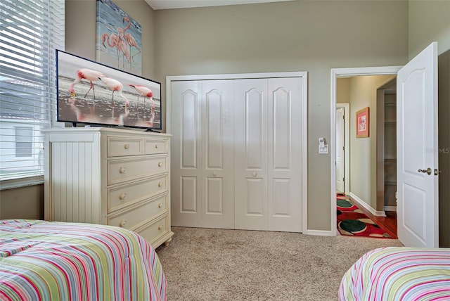 bedroom with a closet and light carpet